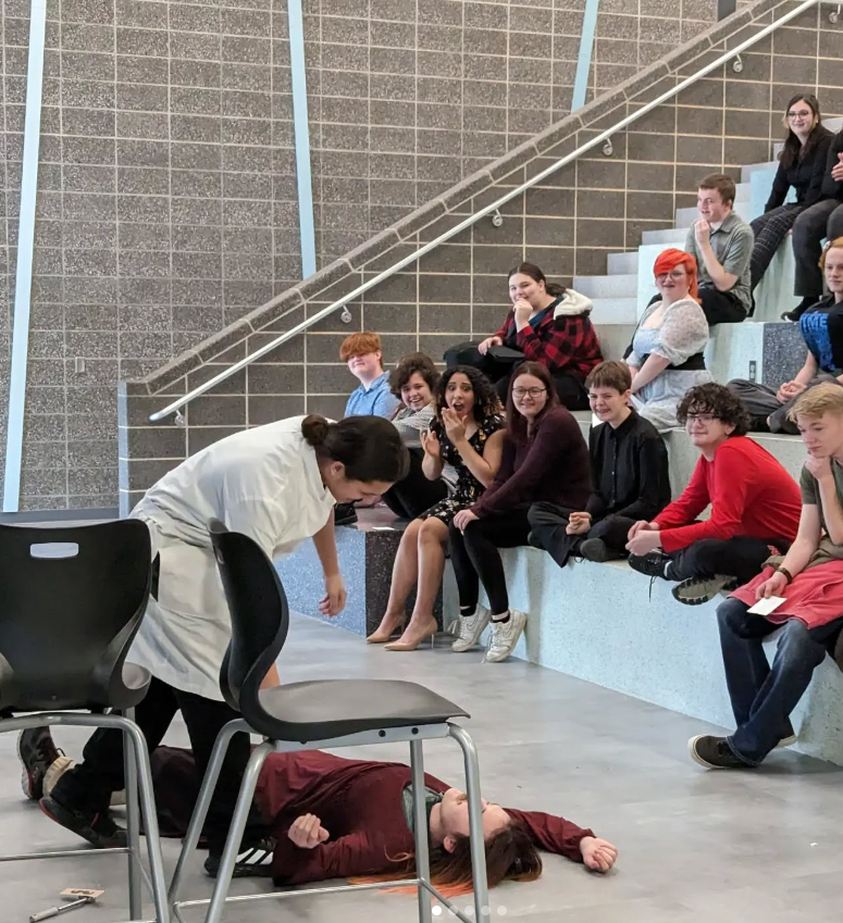 A screenshot from my high schools instagram showing students acting in front of an audience of peers.