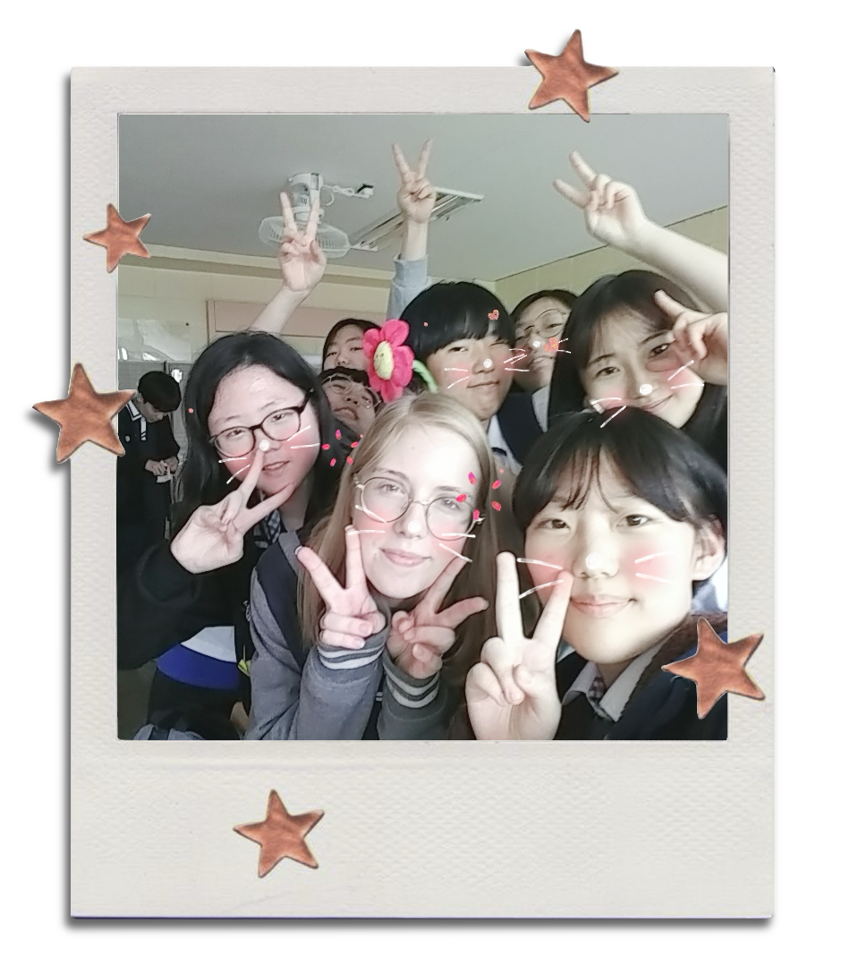A picture of the author in highschool in Korea, surrounded by Korean friends taking a selfie.