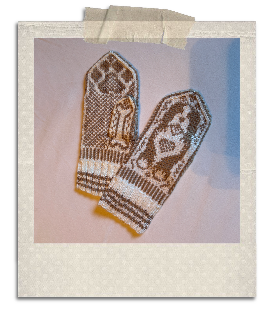 An image of a pair of mittens made by the author; they are white and brown in a Norwegian selbu style, with a dog design.